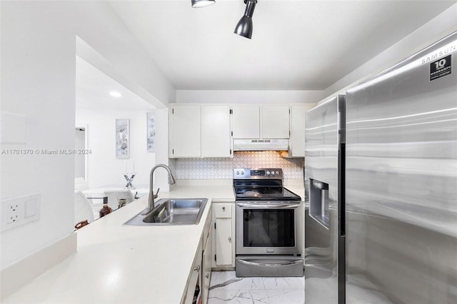 kitchen with white cabinets, decorative backsplash, sink, and stainless steel appliances