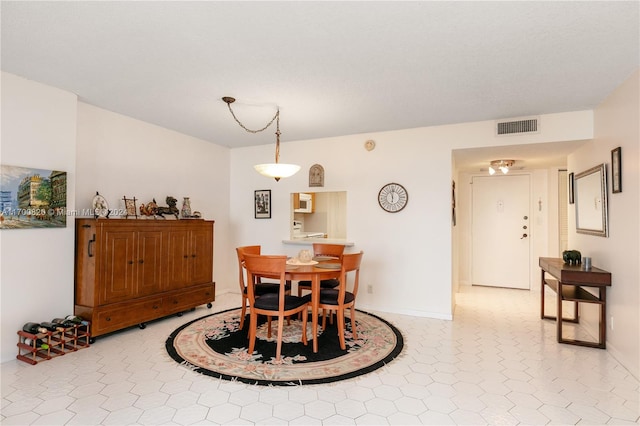 dining area featuring light tile patterned floors