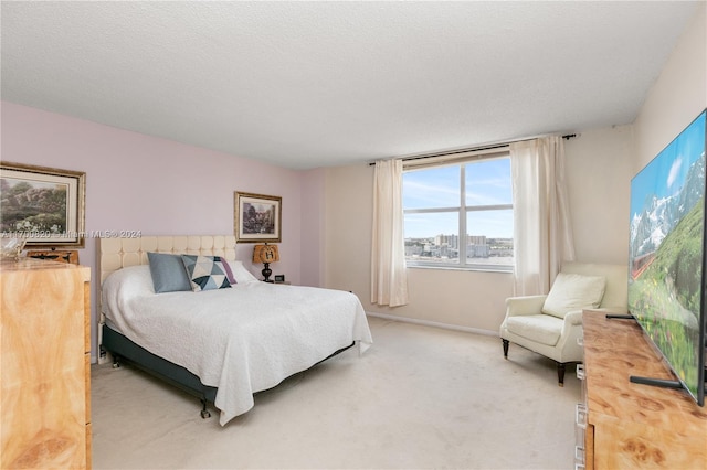 carpeted bedroom featuring a textured ceiling