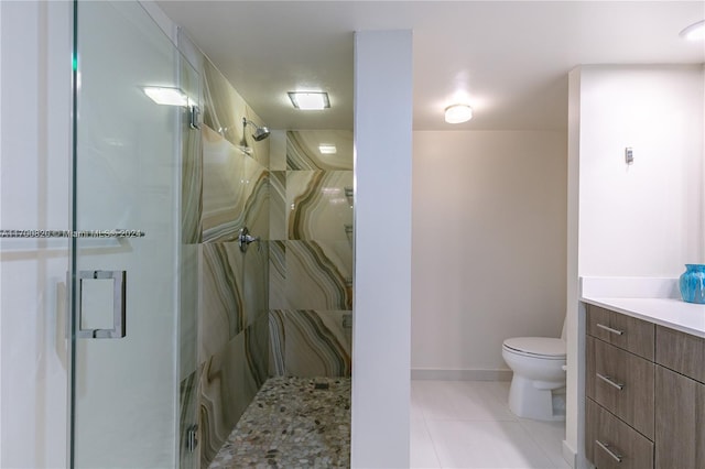 bathroom featuring tile patterned floors, a shower with door, vanity, and toilet