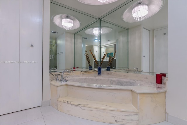 bathroom with tile patterned floors and an inviting chandelier