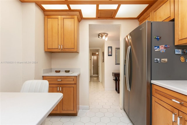 kitchen with stainless steel fridge and light tile patterned flooring