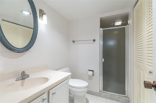 bathroom featuring toilet, tile patterned flooring, vanity, and walk in shower