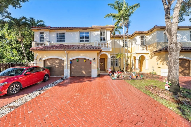 mediterranean / spanish-style home with a balcony and a garage