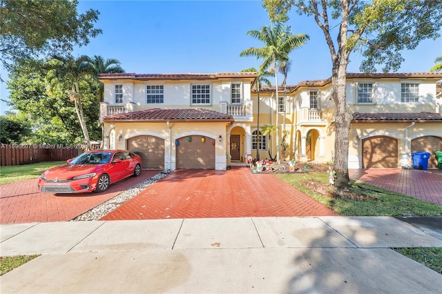 mediterranean / spanish house featuring a balcony and a garage