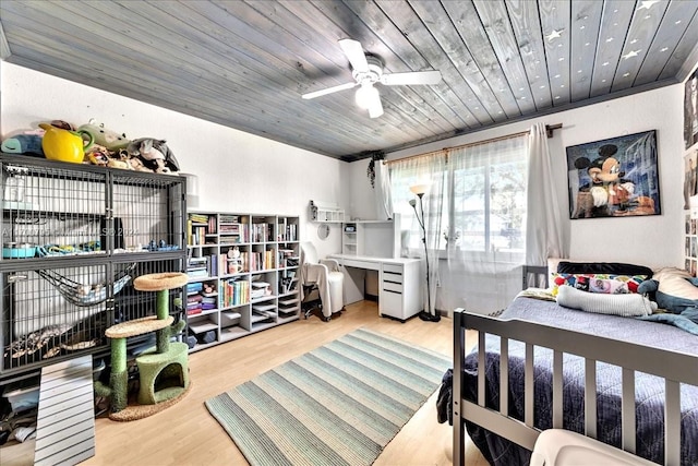 bedroom with ceiling fan, light wood-type flooring, wooden ceiling, and ornamental molding