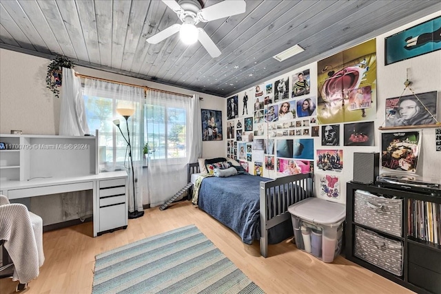 bedroom featuring hardwood / wood-style floors, crown molding, ceiling fan, and wooden ceiling