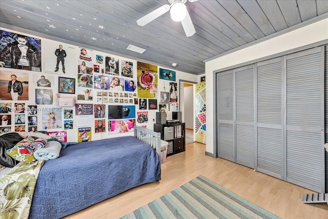 bedroom with wood ceiling, ceiling fan, a closet, and wood-type flooring