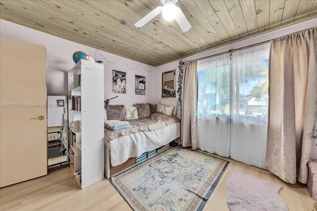 bedroom with ceiling fan, light wood-type flooring, and wood ceiling