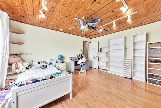 bedroom featuring light hardwood / wood-style floors, track lighting, ceiling fan, and wood ceiling