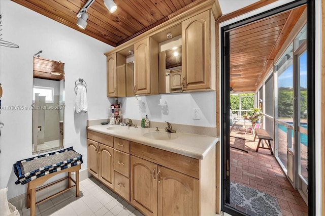 kitchen featuring wooden ceiling, sink, and track lighting