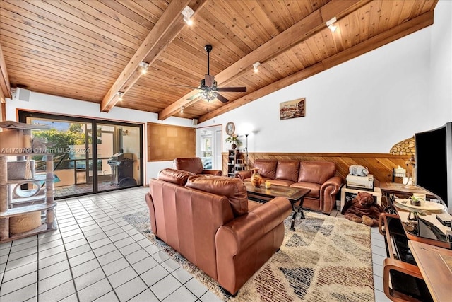 tiled living room featuring lofted ceiling with beams, wooden ceiling, ceiling fan, and wooden walls