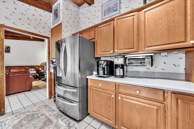 kitchen featuring beam ceiling, stainless steel fridge, and light tile patterned floors