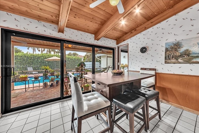 tiled dining room with beamed ceiling, ceiling fan, and wood ceiling