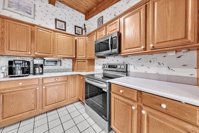 kitchen featuring stainless steel appliances and light tile patterned flooring