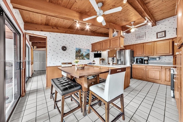 kitchen with ceiling fan, beam ceiling, and wooden ceiling