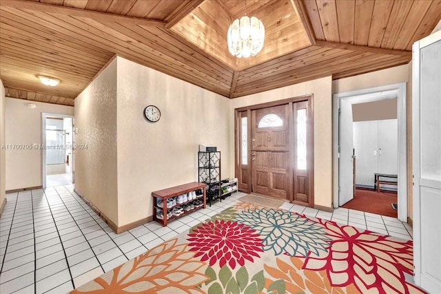 entryway with lofted ceiling, an inviting chandelier, wooden ceiling, and light tile patterned flooring