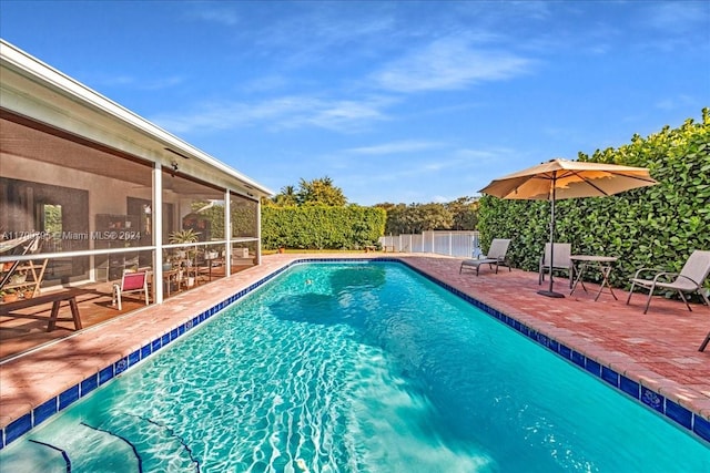 view of pool with a patio area and a sunroom