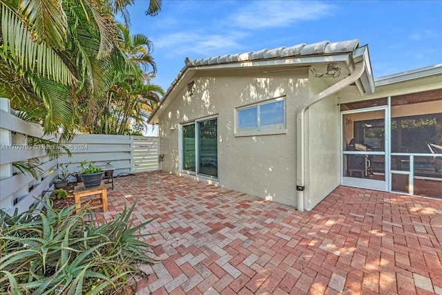 view of patio / terrace featuring a sunroom