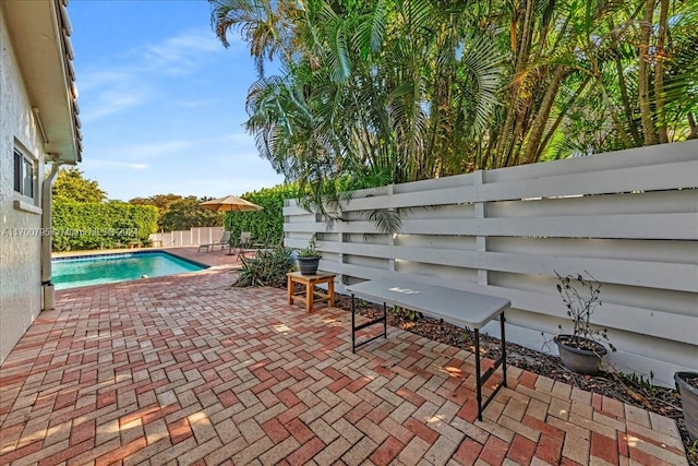 view of patio with a fenced in pool