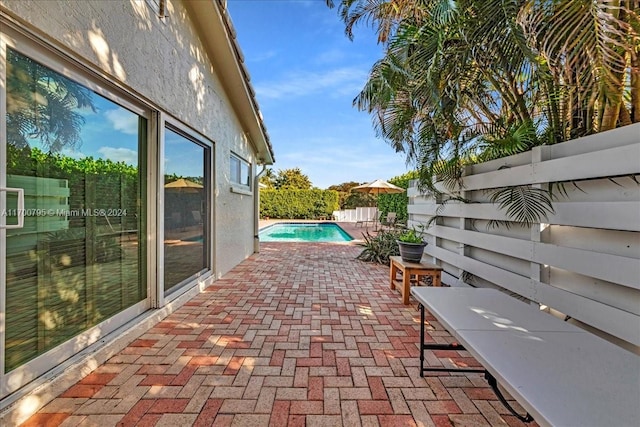 view of patio with a fenced in pool