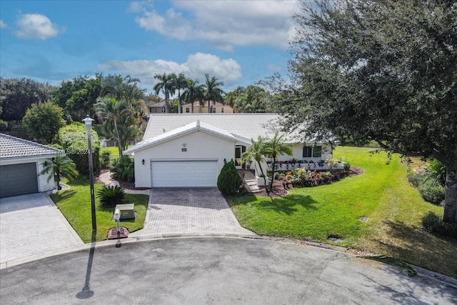 single story home with a front yard and a garage