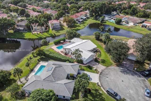 birds eye view of property with a water view