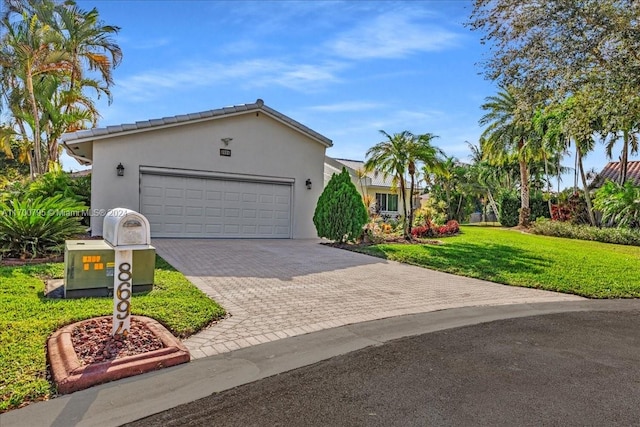 ranch-style home featuring a garage and a front yard