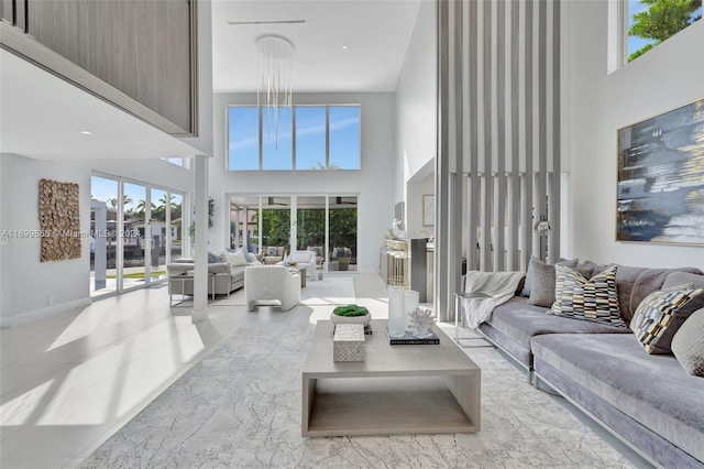 living room featuring a high ceiling and a wealth of natural light