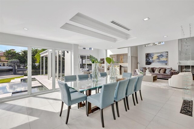 tiled living room with a wealth of natural light, beamed ceiling, and a high ceiling