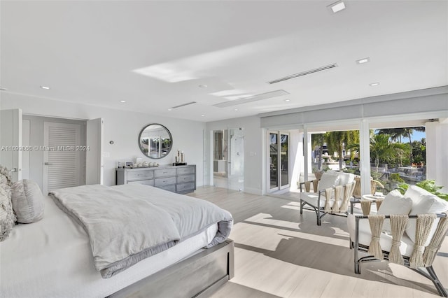 bedroom featuring access to exterior and light wood-type flooring