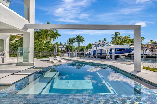 view of pool with an in ground hot tub, a boat dock, and a water view