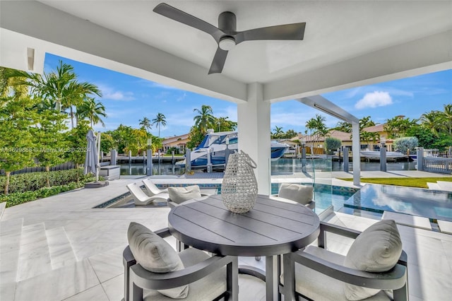 view of patio / terrace featuring ceiling fan and a water view