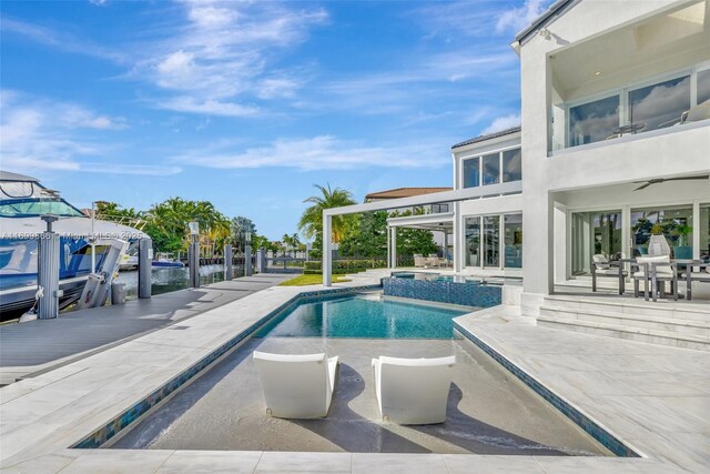 back of house with a fenced in pool and a patio