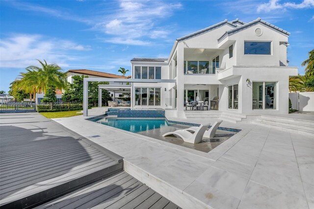 rear view of house with a pool with hot tub, an outdoor hangout area, and a patio area