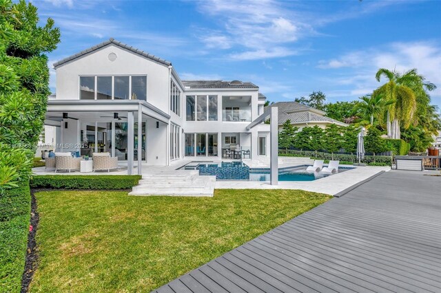 view of dock featuring a patio area, a lawn, and a water view