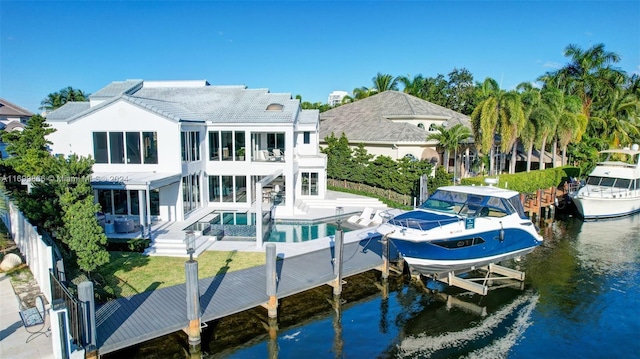 rear view of property featuring a water view and a patio