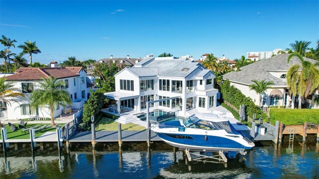 rear view of house featuring a patio and a water view