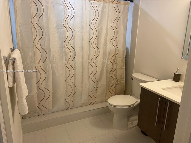 bathroom featuring a shower with curtain, tile patterned flooring, vanity, and toilet