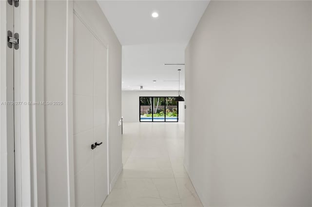 corridor featuring recessed lighting and marble finish floor