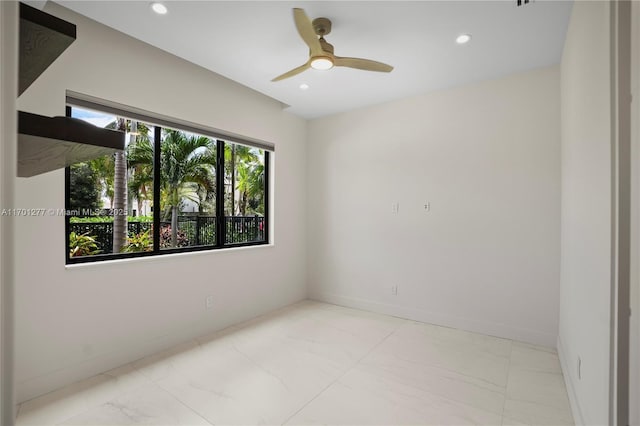 spare room featuring recessed lighting, marble finish floor, and baseboards