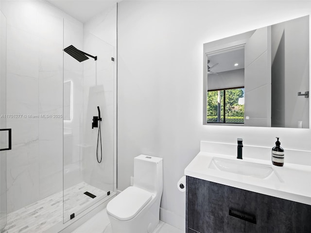 bathroom featuring toilet, a shower stall, vanity, and baseboards