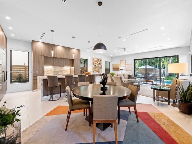 dining room with light tile patterned floors and recessed lighting