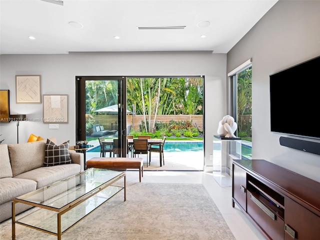 living area featuring visible vents, a wealth of natural light, and recessed lighting