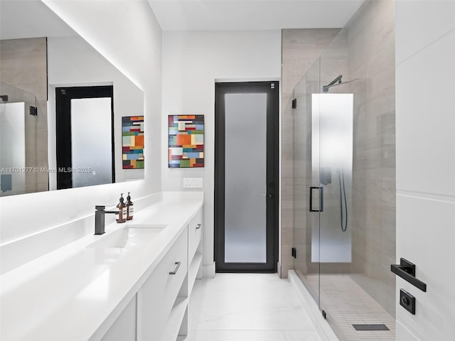 bathroom with a stall shower, marble finish floor, and vanity