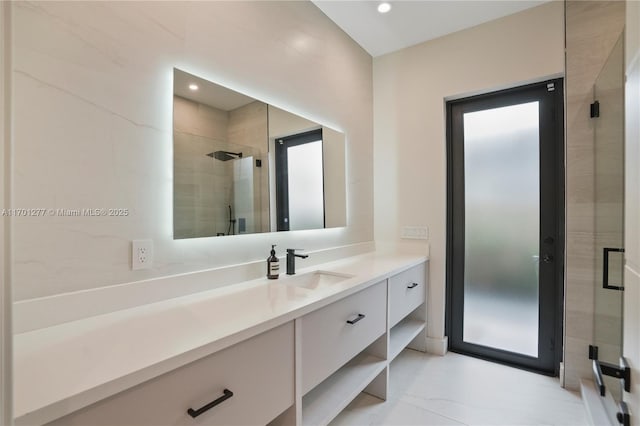 bathroom featuring a stall shower, marble finish floor, recessed lighting, and vanity