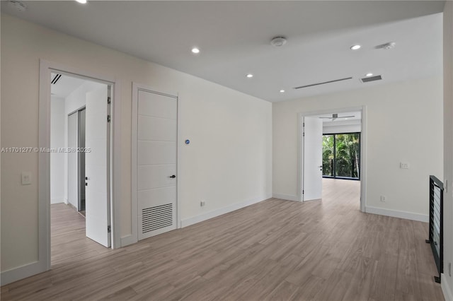 empty room featuring visible vents, recessed lighting, light wood finished floors, and baseboards