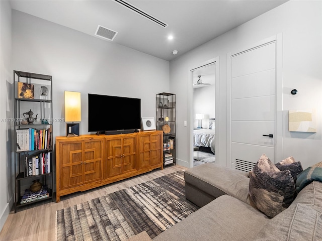 living room with visible vents and wood finished floors