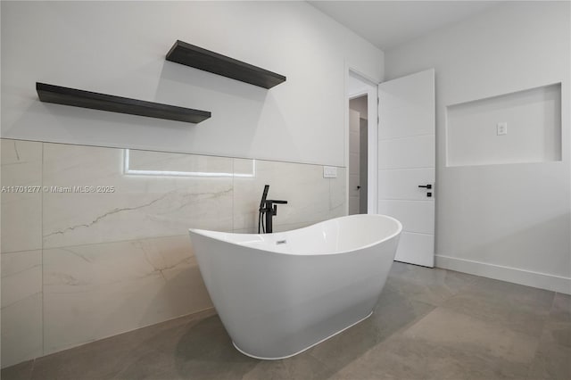 full bath featuring tile walls and a freestanding tub