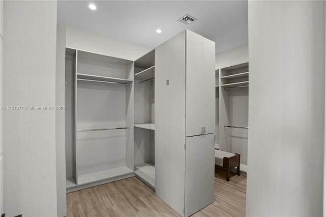 spacious closet with visible vents and light wood-style flooring